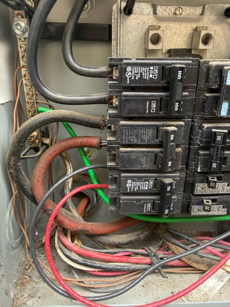Old panel with burnt, corroded breakers and wiring (before replacement) – Zion Electric Inc., San Leandro electrician