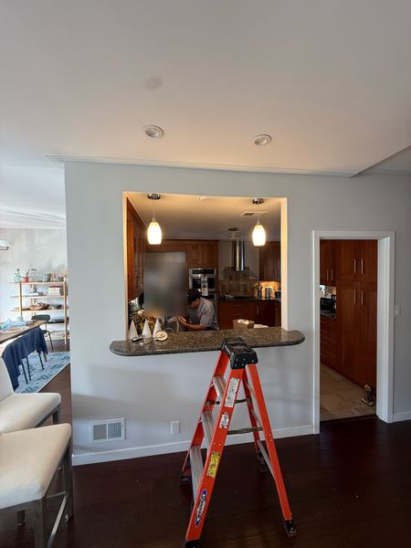 Kitchen pass-through with new pendant lights, Zion Electric technician finishing up – Zion Electric Inc., San Leandro electrician