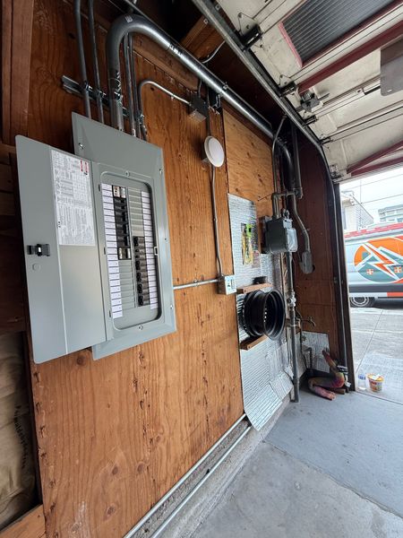 New panel in a garage, with the Zion Electric van outside – Zion Electric Inc., San Leandro electrician
