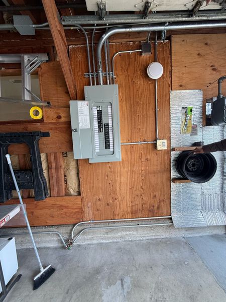 New panel mounted on a plywood wall with conduit – Zion Electric Inc., San Leandro electrician