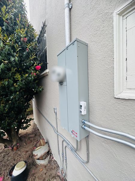 New meter/main panel on an exterior side wall with conduit runs – Zion Electric Inc., San Leandro electrician