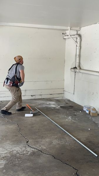 Zion Electric technician bending conduit in a carport β Zion Electric Inc., San Leandro electrician