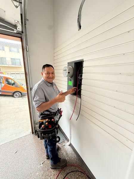 Zion Electric technician at a new meter and panel upgrade, with the Zion Electric van – Zion Electric Inc., San Leandro electrician