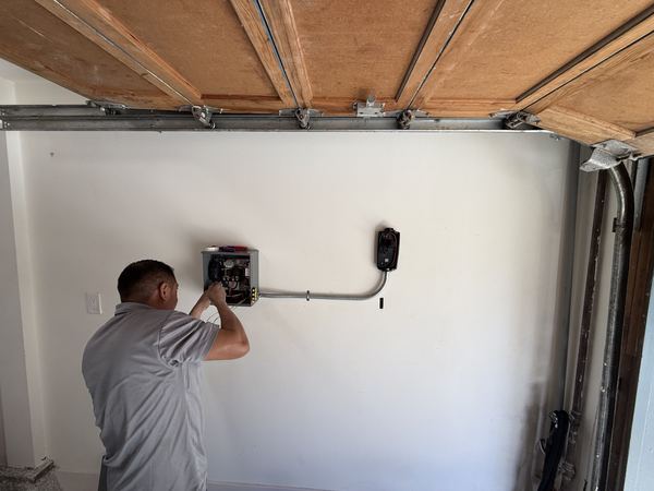 Zion Electric technician wiring a DCC load controller for an EV charger – Zion Electric Inc., San Leandro electrician
