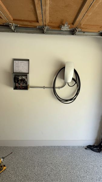 Thermolec DCC load controller with a Tesla Wall Connector in a garage – Zion Electric Inc., San Leandro electrician