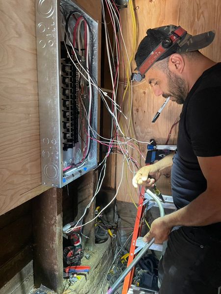 Zion Electric technician wiring an open panel β Zion Electric Inc., San Leandro electrician