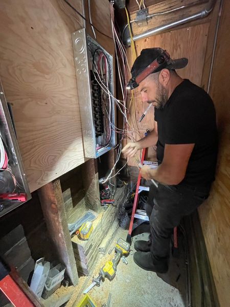 Zion Electric technician working at a panel – Zion Electric Inc., San Leandro electrician